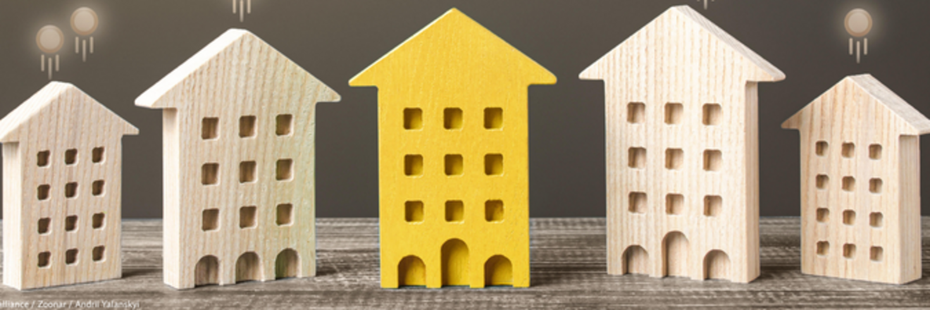 Image Description: Five miniature wooden house models on a weathered wood surface. Four houses are natural light wood, while the central house is bright yellow, making it stand out. Each house has grid-pattern windows and arched doorways. Small glowing orbs float above each house - three bright yellow orbs above the yellow house, and one or two tan orbs above the others. The composition suggests themes of home selection or finding a special property.